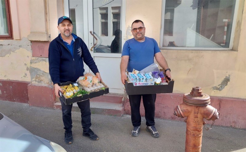 Sorin and Iosif with food boxes for needy families.